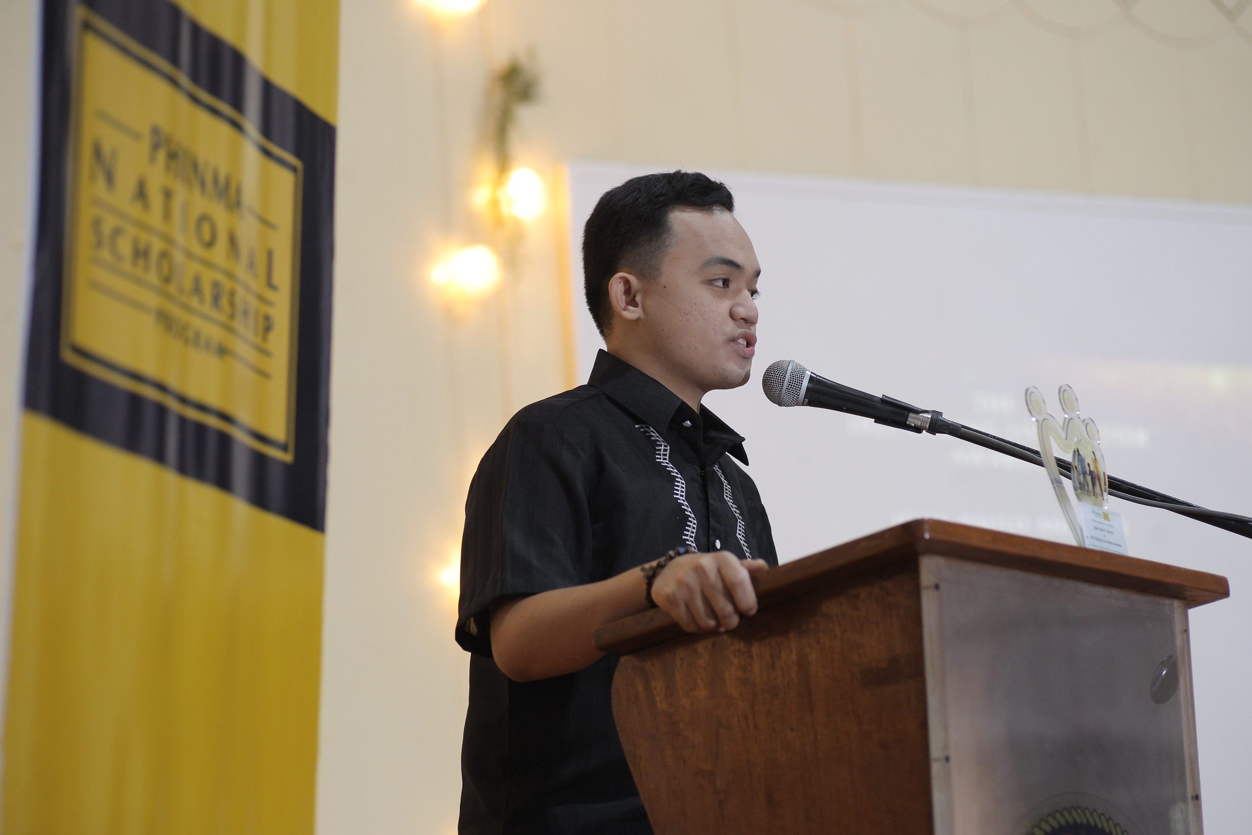 John Paul Aniceto, a graduate of the PHINMA National Scholarship Program, was recognized for embodying PHINMA values. He was honored in a ceremony held at his alma mater, the Philippine Normal University.